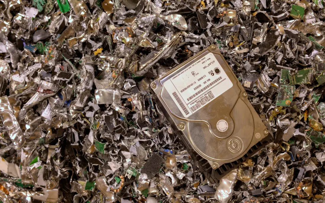 Destroyed hard drive and shredded electronic waste for e-waste recycling