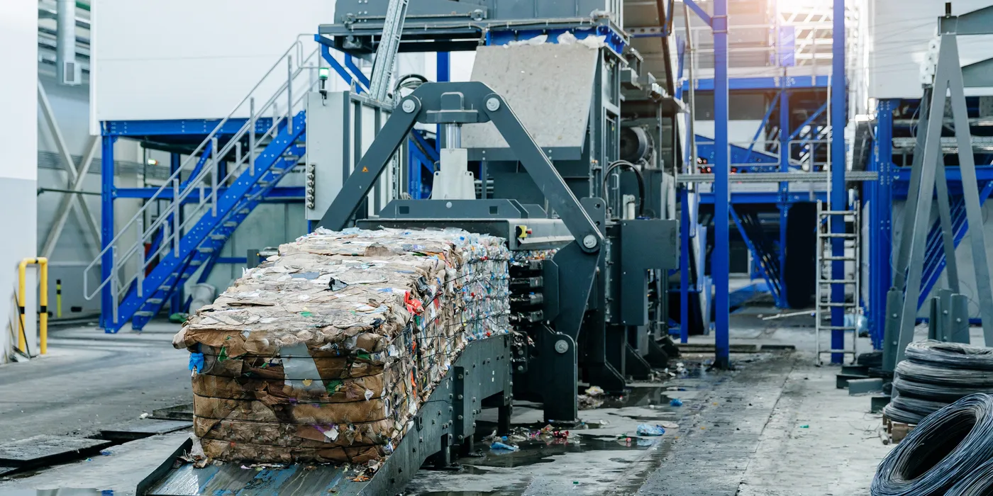Baled paper waste prepared for single shaft shredder processing