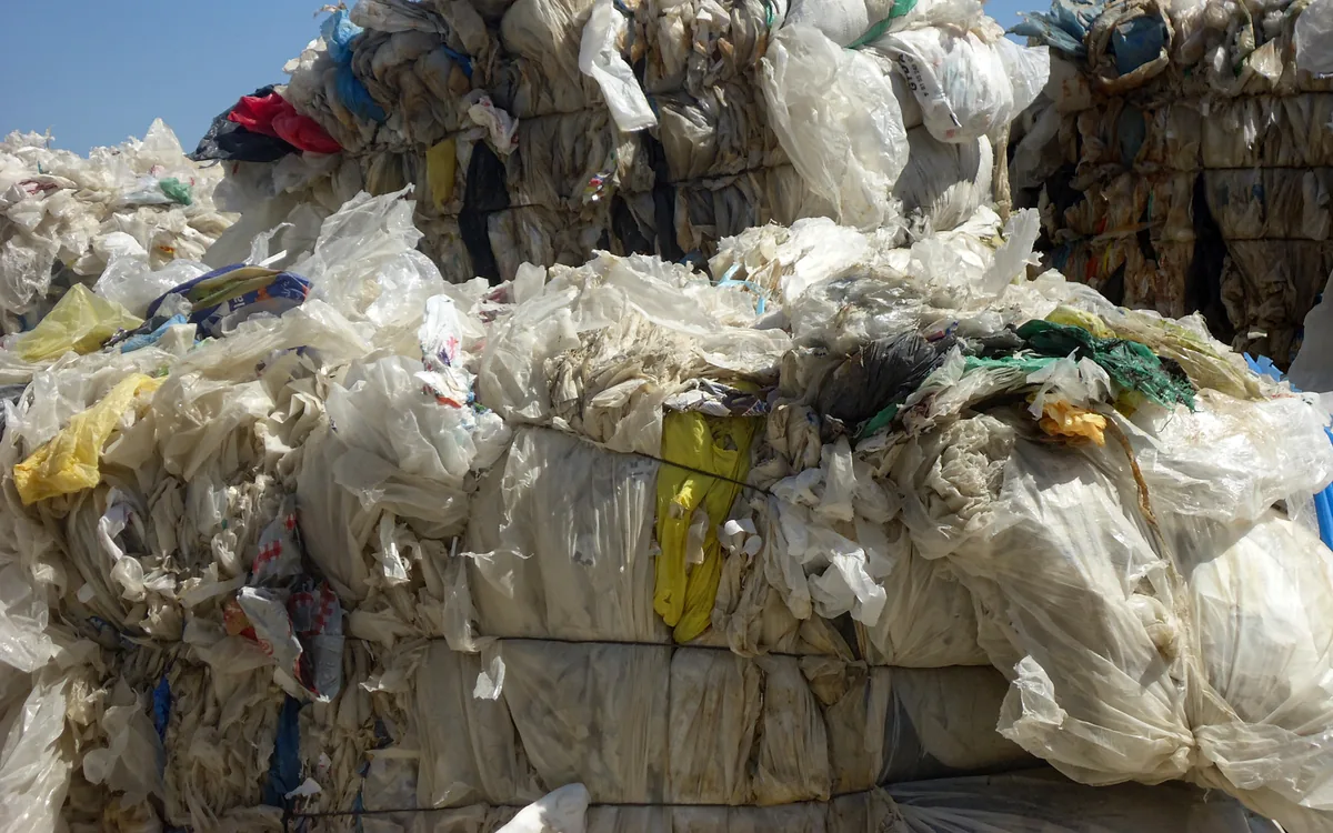 Baled waste plastic film and bags prepared for plastic shredder recycling