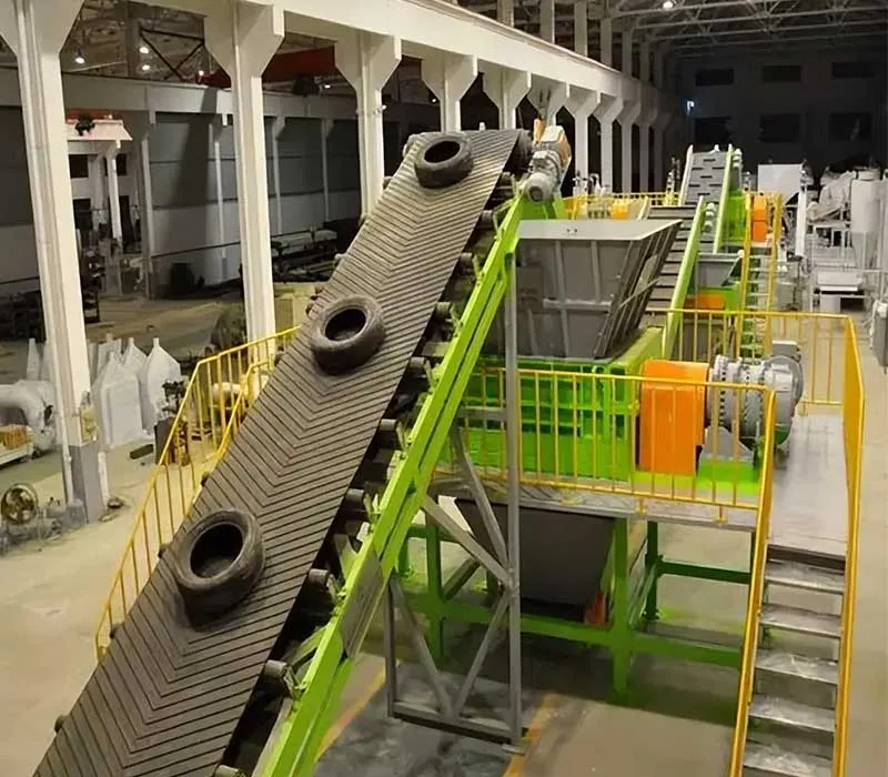 Tire shredder reducing waste tires in a recycling line