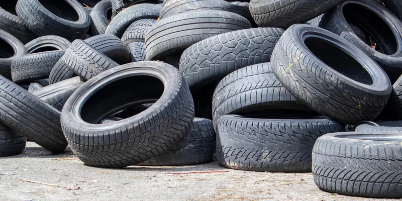 Passenger car tires prepared for tire shredder recycling